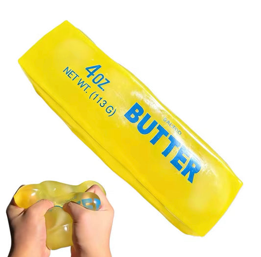 Yellow Vaseline Butter squishy with blue BUTTER lettering, shown whole and being squeezed